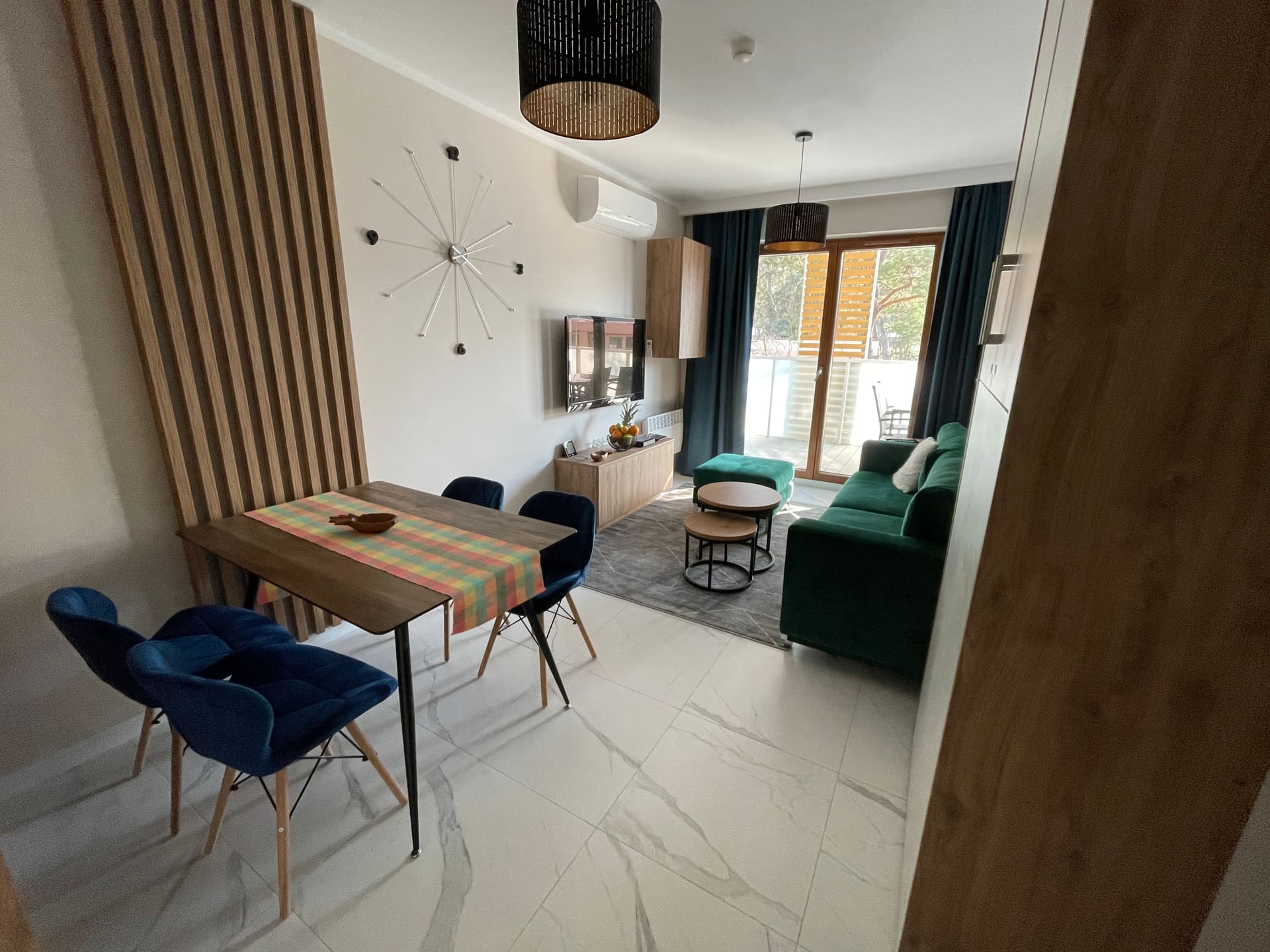 Salon z rozkładaną kanapą i aneksem w Apartamencie Lawendowym